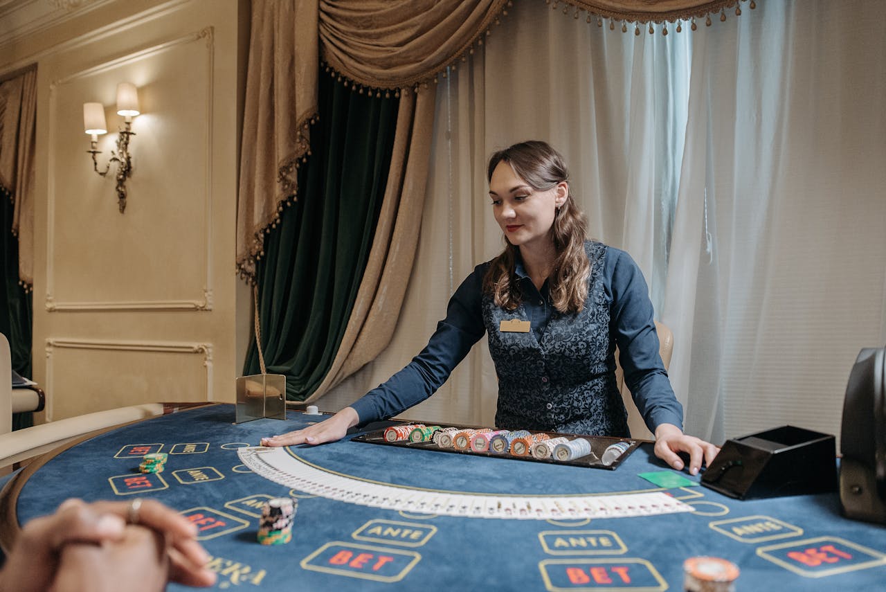 about-01 Casino dealer managing cards and chips in an elegant gambling setting.