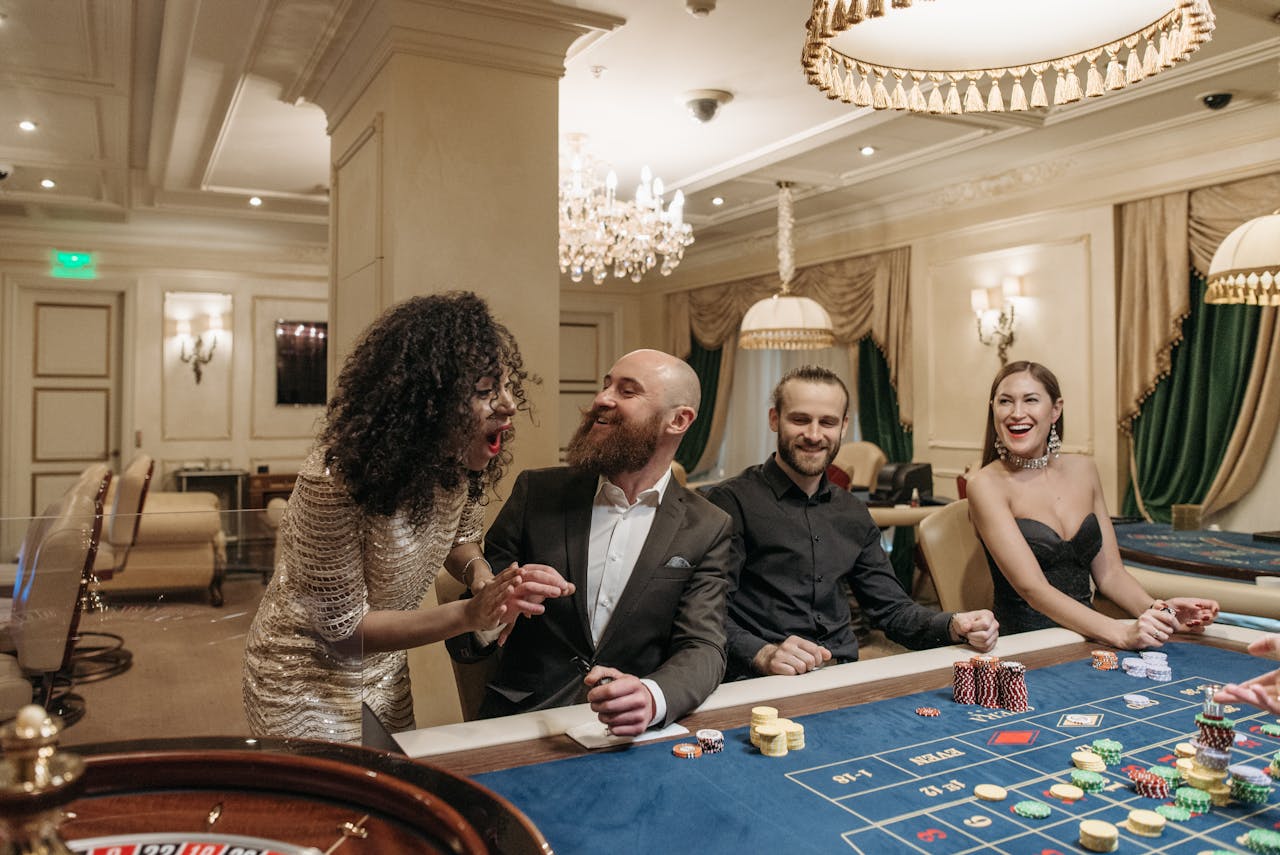 services-img Group of adults enjoying a lively night at a casino poker table, gambling with friends.